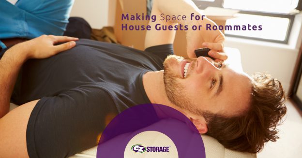 Man on his phone laying on a bed with text "Making Space for House Guests or Roommates"
