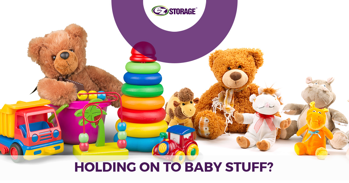 Collection of baby toys with text "holding on to baby stuff"