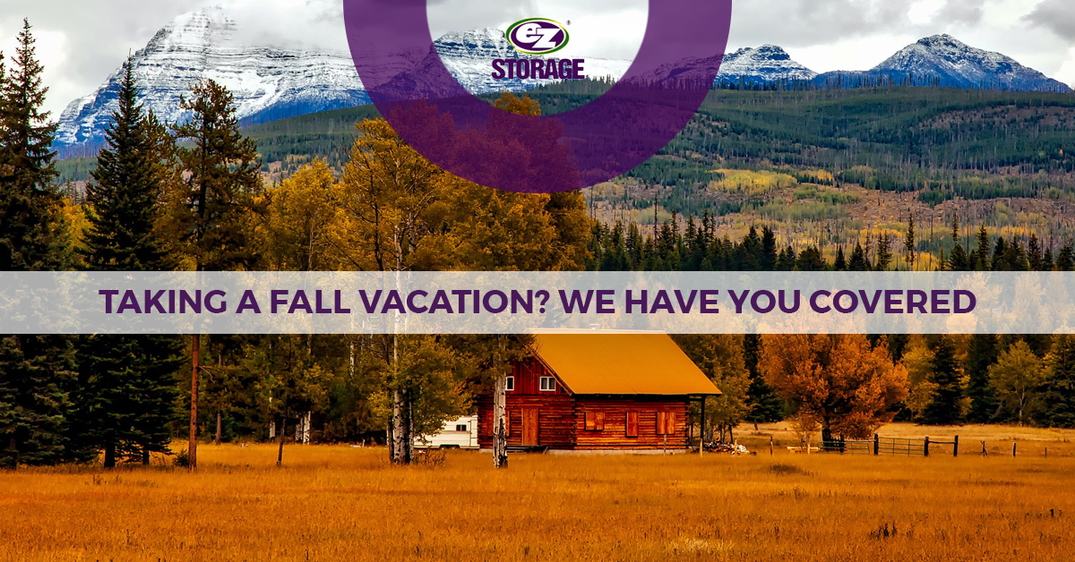 Wooden cabin near fields and mountains with EZ Storage logo and text "Taking a Fall Vacation? We Have You Covered"