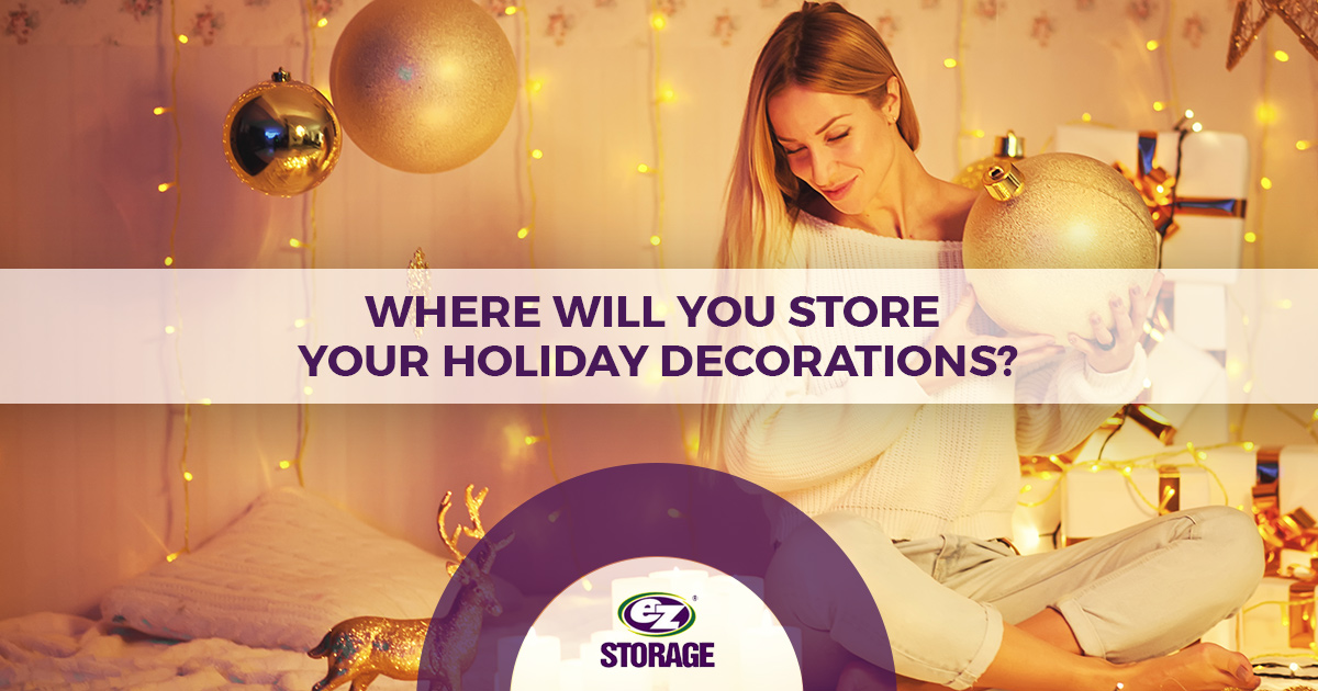 Woman putting up holiday decorations with EZ Storage logo and text "Where Will You Store Your Holiday Decorations?"