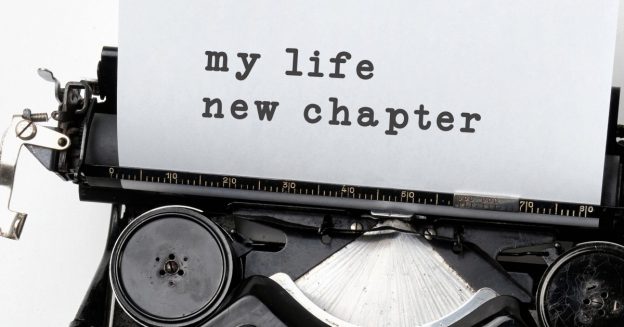 Close up of typewriter with paper rolling out and text, "my life new chapter."
