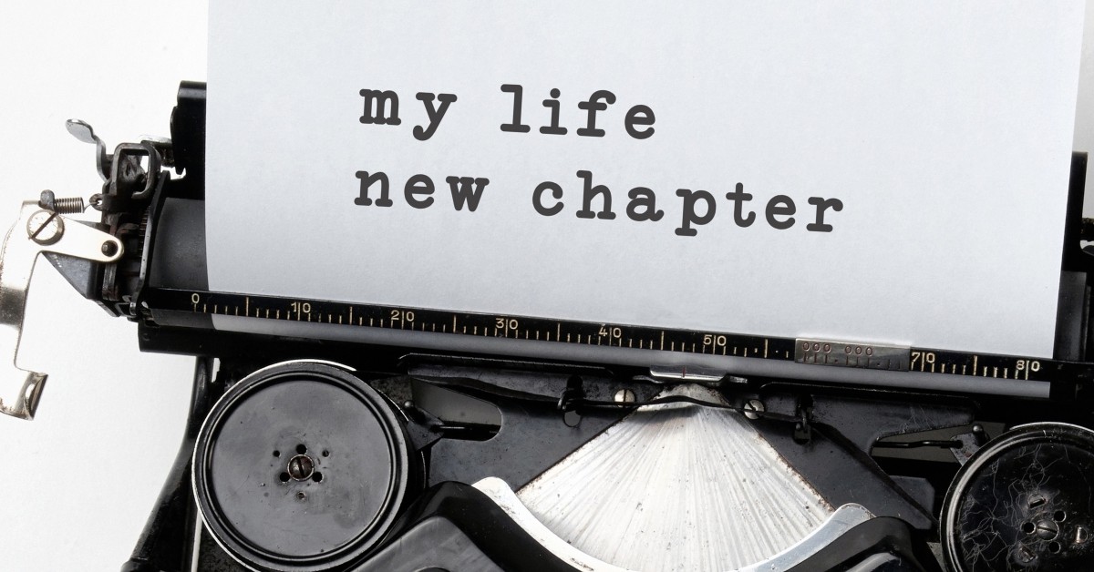 Close up of typewriter with paper rolling out and text, "my life new chapter."