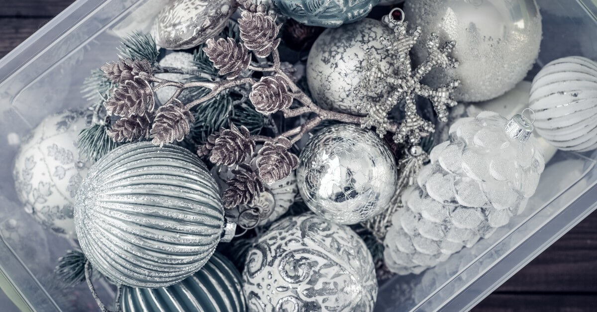 Close up of frosted holiday ornaments in a coffee table decorative bowl.