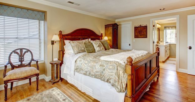 Remodeled guest bedroom with wooden bed frame