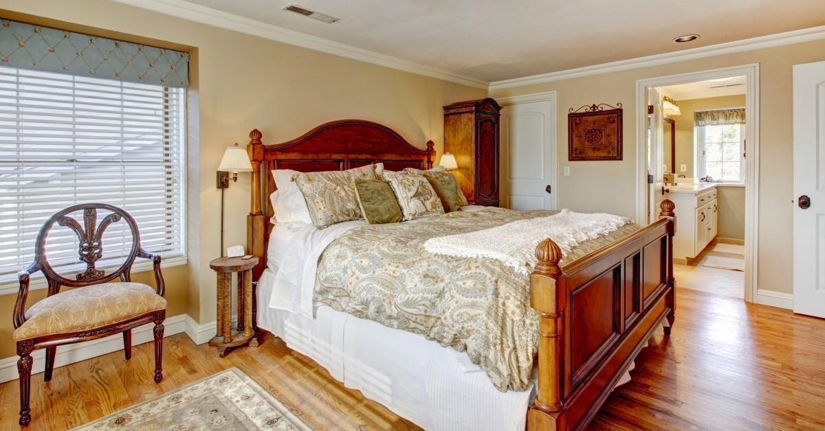 Remodeled guest bedroom with wooden bed frame